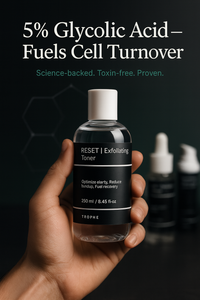 Hand holding a bottle of Trophe Exfoliating Toner with text about glycolic acid on a dark background